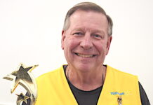 Local Shining Star Greeter presented with a trophy