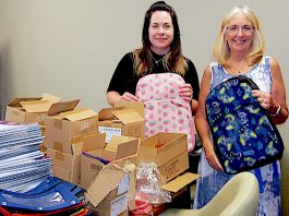 Meridian Credit Union Port Elgin filling school backpacks for kids